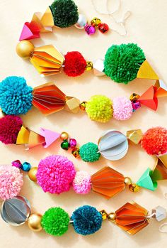 the colorful pom - poms are hanging on the wall