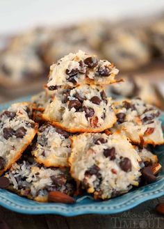 chocolate chip cookies stacked on top of each other in a blue plate with almonds