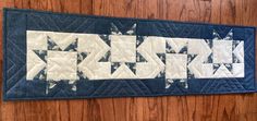 a blue and white quilted wall hanging on a wooden door