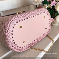 a pink purse sitting on top of a table