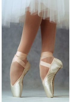 the feet of a ballerina in ballet shoes