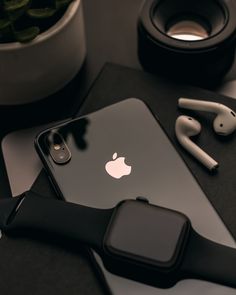 an apple phone and earphones on a table