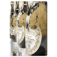 three wine bottles with the eiffel tower in the background and gold foil on them