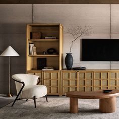 a living room filled with furniture and a flat screen tv mounted on a wall above it