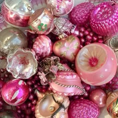 a plate filled with lots of pink and gold ornaments