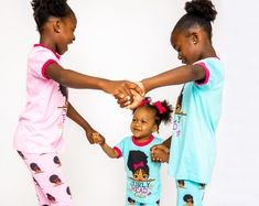 ABOUT THIS ITEM Celebrate natural beauty and self-confidence with our "Curly Head Cutie" pajama set – a delightful ode to embracing one's uniqueness in the most adorable way. This set isn't just sleepwear; it's a declaration of self-love, positivity, and the joy of being authentically you. Imagine your little ones slipping into this charming ensemble. The pajama top features a heartwarming illustration of a curly-haired girl, each radiating with confidence and charm. As they put on their pajamas Silk Pajamas Kids, Black Kids In Pajamas, Playful Character Print Sleepwear For Bedtime, Playful Character Print Sleepwear With Short Sleeves, Justice Pajamas, Cozy Sleepwear, Learning Poster, Building Self Esteem, Girls Sleepwear