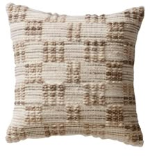 a white and brown pillow with squares on it's back side, against a white background