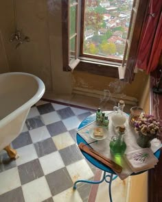 a bath tub sitting next to a window filled with lots of bottles and soaps