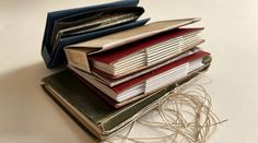 a stack of books sitting on top of each other next to a pair of scissors