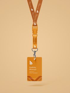 an orange lanyard with a name tag hanging from it's side, on a beige background