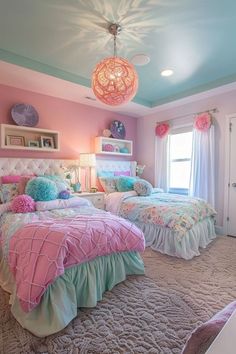 two beds in a room with pink walls and blue ceilinging, one has a chandelier hanging from the ceiling