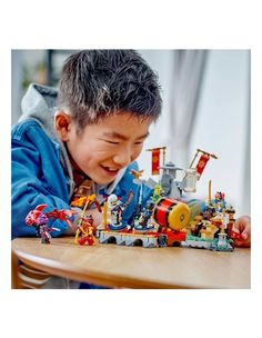 a young boy playing with toys on a table