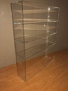 an empty glass display case sitting on top of a wooden floor