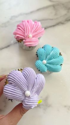 three cupcakes that have been made to look like flowers