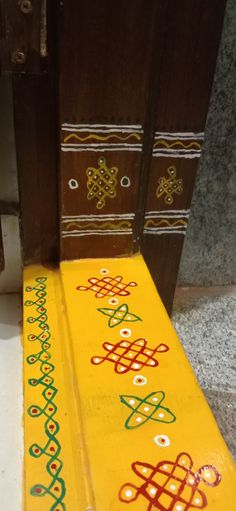 a wooden door with decorative designs painted on it