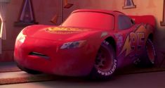 a cartoon character is standing next to a car in the disney pixar movie