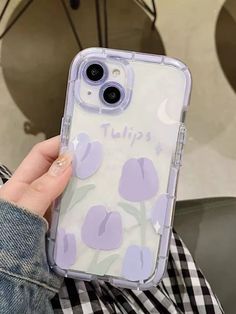 a person holding up an iphone case with flowers on the front and purple tulips on