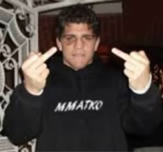 a man in a black hoodie making two fingers up