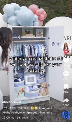 a woman standing in front of a baby's closet