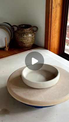 a bowl sitting on top of a counter next to a window