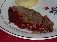 a piece of meatloaf on a white and blue plate