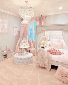 a bedroom decorated in pink and white with a chandelier