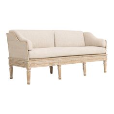 a white couch sitting on top of a wooden frame