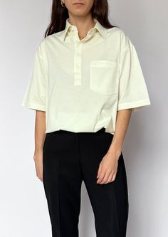 Vintage 90s cream half placket top. A heavier weight fabric with slight stretch. Features a large pocket, half placket detail and boxy shape. Size - S/M/L / UK 8-16 / US 4-12 / EU 36-44. Size label reads M Model is 5'4 and a size UK 6-8. Bust circ: 116cm / Length: 70cm / Sleeve length (drop shoulder): 28cm Excellent condition. Made by Gabiici. 52% Cotton, 48% Polyester. Found in the UK, based in London. Classic Cream Shirt With Pockets, Classic Oversized Tops With Collared Neckline, Cream Cotton Tops With Button Closure, Cotton Cream Tops With Button Closure, Cream Short Sleeve Workwear Shirt, Classic Cream Shirt For Everyday, Oversized Collared Tops For Work, Cream Relaxed Fit Shirt For Everyday, Oversized Collared Classic Top