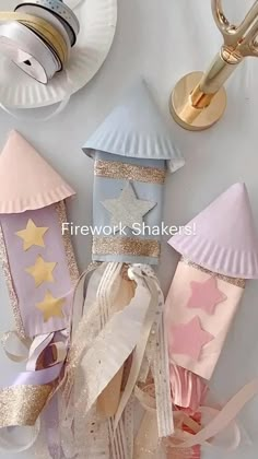 paper plates and other decorative items are arranged on a white tablecloth with the words firework shakers above them