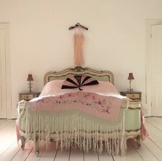 a bed with a pink blanket on top of it