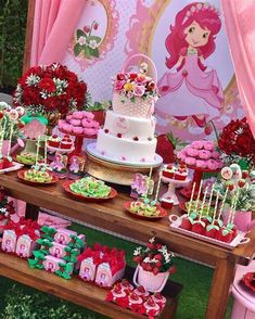 a table topped with lots of cakes and cupcakes