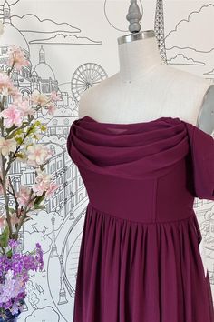 a dress on a mannequin next to flowers