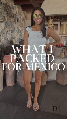 a woman standing in front of a stone wall with the words what i packed for mexico