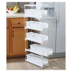 a white shelf filled with baskets next to a refrigerator