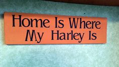 a sign that says home is where my harley is on the wall in front of a door