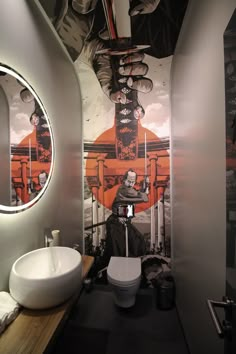 a bathroom with a sink, mirror and toilet in it's stall area next to a painting on the wall