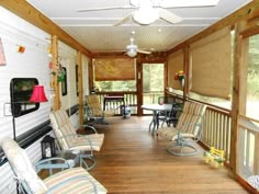 a porch with several chairs and tables on it