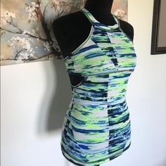 New With Tags Workout Top With Support Bra Built In. Size X-Small And With A Cool And Unique Cut Out On The Sides Of The Top. Comes From A Pet And Smoke Free Home. Trendy Fitted Sports Tank Top, Fitted Athleisure Tank Top For Spring, Spring Athleisure Fitted Tank Top, Sporty Fitted Tank Top For Spring, Fitted Multicolor Tank Top For Gym, Spring Fitted Sports Tank Top, Fitted Spring Sports Tank Top, Fitted Tank Top For Spring Sports, Green Fitted Workout Tank Top