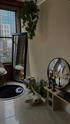 a living room filled with furniture next to a window and a plant in the corner