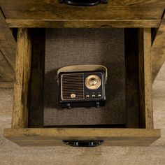 an old fashioned radio sitting on top of a wooden table