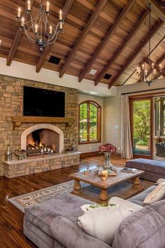 a living room with couches and a fire place in it's center area