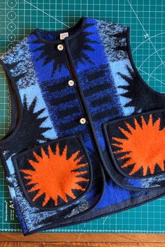 Vest/gilet hand made from a reclaimed vintage blanket with orange suns on the pockets Recycled Blankets, Semi Formal Outfit, Recycled Clothing, Sewing School, Blanket Coat, Repair Clothes, Casual Outfit Inspiration, Ethical Fashion Brands, Wooden Buttons