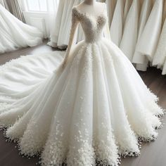 a white wedding dress with flowers on the skirt