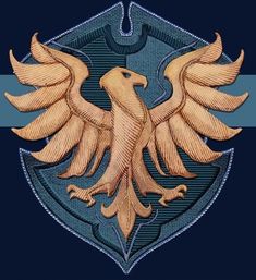 a golden eagle sitting on top of a blue shield