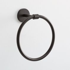 a black towel ring on a white wall