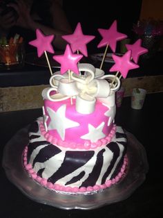 a pink and white cake with stars on top