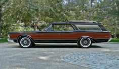 an old station wagon parked in a driveway