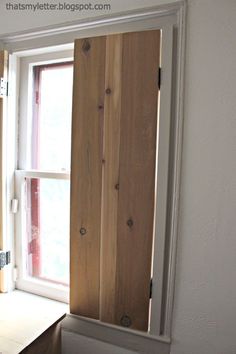 an open window with wooden slats in it