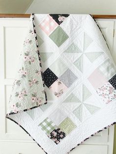 two quilts are laying on top of each other, one is green and the other is pink