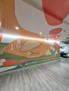 a large mural on the side of a wall in an office building with wood flooring